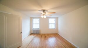 bedroom with wood floors, large windows and ceiling fan at 3101 pennsylvania apartments in randle highlands washington dc