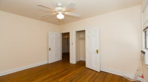 vacant bedroom with hardwood floors, large closet and ceiling fan at 4020 Calvert street apartments in washington dc