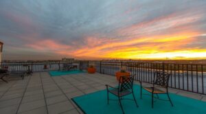 rooftop lounge at dusk with social seating and views of the city from the norwood apartments in washington dc