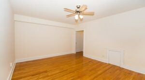 vacant living area with wood floors and ceiling fan at the klingle apartments in cleveland park washington dc