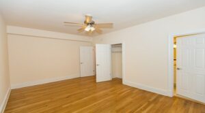 vacant bedroom with hardwood floors, closet and view of bathroom at the klingle apartments in cleveland park washington dc