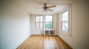 vacant bedroom with large windows, ceiling fan and wood flooring at the cortland apartments in adams morgan washington dc