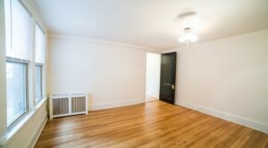 vacant bedroom with ceiling fan, hardwood floors and large windows at the cortland apartments in adams morgan washington dc