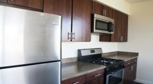 kitchen with stainless steel appliances and gas range at sheridan station apartments in anacostia washington dc