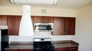 kitchen with espresso cabinets and modern lighting at sheridan station apartments in anacostia washington dc