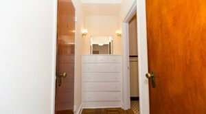 hallway view of build in dresser and mirror at 1401 sheridan apartments in washington dc