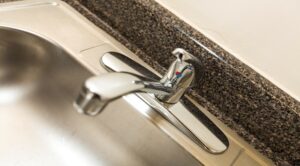 closeup of stainless steel kitchen sink at 1401 sheridan apartments in washington dc