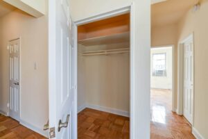 hallway showing large closet and bedroom with hardwood floors at 1401 sheridan apartments in washington dc