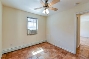 bedroom with wood floors and ceiling fan at alpha house apartments in columbia heights washington dc
