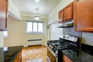 kitchen with stainless steel appliances, gas range and view of dining area at sherry hall apartments in washington dc