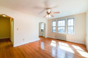 living area with wood floors, large windows and ceiling fan at 3101 pennsylvania apartments in randle highlands washington dc