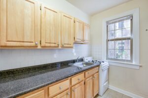 kitchen with gas range, tile backsplash and window at mount pleasant apartments in nw washington dc