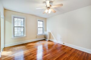 living area with wood floors and ceiling fan at mount pleasant apartments in nw washington dc