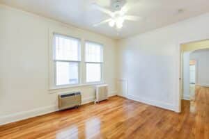 living area with wood floors, large windows and ceiling fan at 3213 Wisconsin apartments in cleveland park washington dc