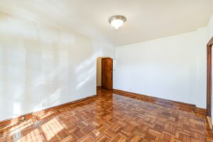 vacant living area with hardwood floors and view of front entrance at the eddystone apartments in washington dc