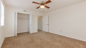 bedroom with large closet and ceiling fan at grandview village apartments in shipley terrace washington dc