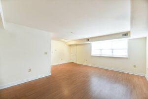 vacant living area with large windows and wood flooring at jasper place tax credit apartments in congress heights washington dc