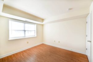 bedroom with large windows ant hardwood flooring at jasper place tax credit apartments in congress heights washington dc