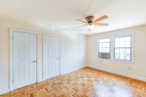 bedroom with hardwood floors, ceiling fan and windows at meridian park apartments in columbia heights nw washington dc