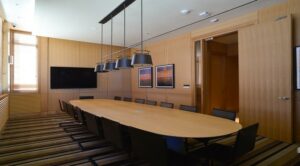 Conference Room with large table, chairs and monitor at park chelsea at the collective apartments in capitol riverfront washington dc