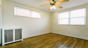 bedroom with ceiling fan and wood floors at pleasant hills apartments in washington dc