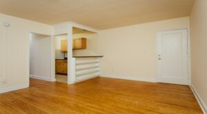 open view of apartment showing living area and kitchen at pleasant hills apartments in washington dc
