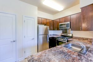 kitchen with stainless steel appliances and breakfast bar at sheridan station apartments in anacostia washington dc