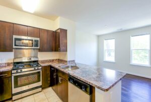 kitchen with stainless steel appliances, and view of dining area at sheridan station apartments in anacostia washington dc