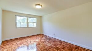 bedroom with wood floors and windows at shipley park apartments in washington dc