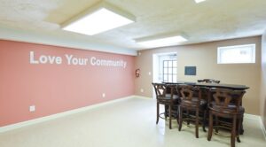 community room with table and bar seating at shipley park apartments in washington dc