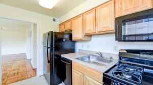 kitchen with refrigerator, dish washer, gas range and view of dining area at shipley park apartments in washington dc