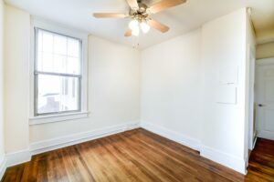 vacant room with window, ceiling fan and wood floors at the cortland apartments in adams morgan washington dc