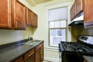 kitchen with wood cabinetry, gas range and window at the cortland apartments in adams morgan washington dc