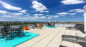 rooftop lounge with social seating and view of city from the norwood apartments in washington dc