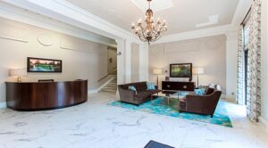 lobby lounge with social seating, modern lighting, artwork and concierge desk at the calverton apartments in adams morgan washington dc
