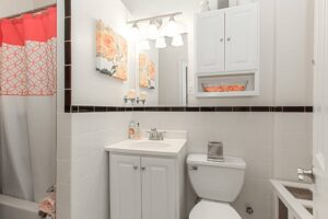 bathroom with tub, toilet, sink and large mirror at the calverton apartments in adams morgan washington dc