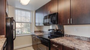 kitchen with modern cabinets, window and lots of counter space at juniper courts tax credit apartments in takoma washington dc