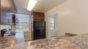 large kitchen with breakfast bar and window at juniper courts tax credit apartments in takoma washington dc