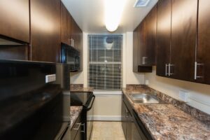 kitchen with modern cabinets and window at juniper courts tax credit apartments in takoma washington dc