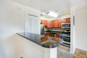 kitchen with stainless steel appliances and breakfast bar at naylor overlook apartments in se washington dc