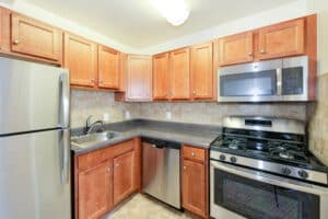 kitchen with stainless steel appliances and tile backsplash at naylor overlook apartments in se washington dc