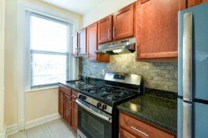 kitchen with stainless steel appliances, tile backsplash and window at 2701 Connecticut apartments in washington dc