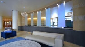 lobby lounge with social seating, modern lighting and view of concierge desk at park chelsea at the collective apartments in capitol riverfront washington dc