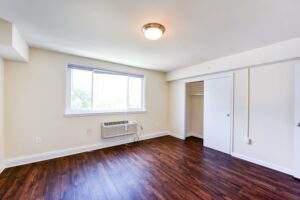 bedroom with hardwood flooring at longfellow apartments in brightwood washington dc
