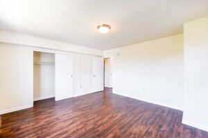 bedroom with sliding closet doors and hardwood flooring at longfellow apartments in brightwood washington dc
