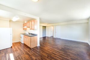 open layout of apartment showing kitchen, living and dining areas at longfellow apartments in brightwood washington dc