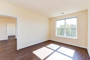 bedroom with large windows and hardwood flooring at archer park apartments in congress heights washington dc