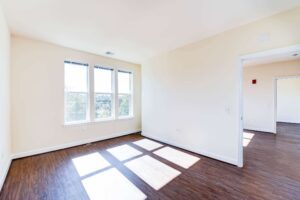 bedroom with large windows and hardwood flooring at archer park apartments in congress heights washington dc