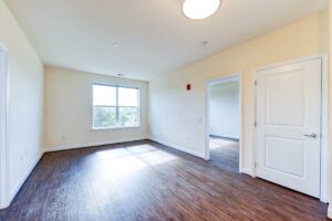 living area with large windows and hardwood flooring at archer park apartments in congress heights washington dc