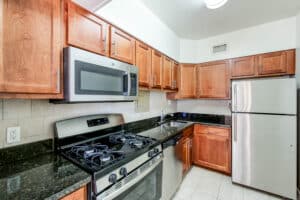 kitchen with stainless steel appliances, gas range and tile backsplash at clarence house apartments in washington dc